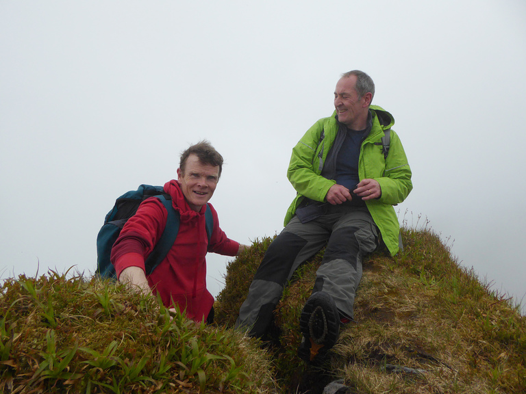 Brendan and Donal sitting atop the Hag's Tooth in the Reeks